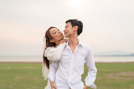 Happy young Asian couple in bride and groom clothing ready for marry and wedding celebrateの写真素材