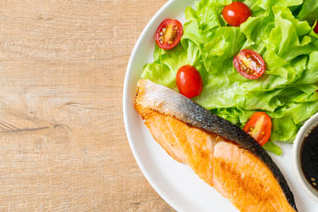 grilled salmon fillet steak with vegetable salad - healthy food styleの写真素材