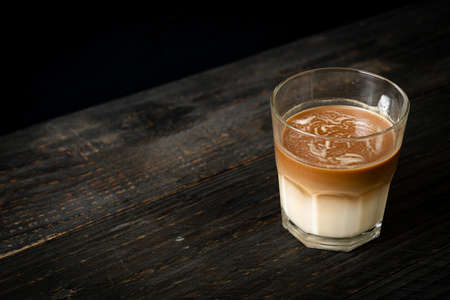glass of latte coffee, coffee with milk on wood backgroundの写真素材
