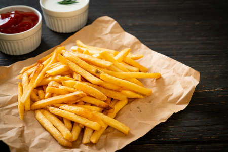 French fries or potato chips with sour cream and ketchupの写真素材