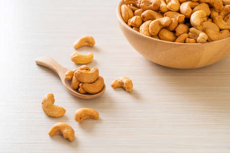 Cashew nuts in wooden bowl with copy space