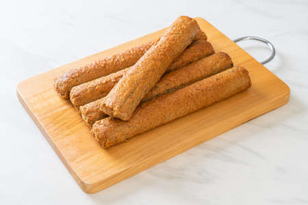 fried Chinese fish cake or fish ball line on wood boardの写真素材