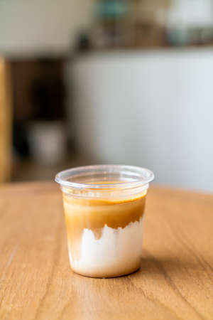 Dirty Coffee - A glass of espresso shot mixed with cold fresh milk in coffee shop cafe and restaurantの写真素材