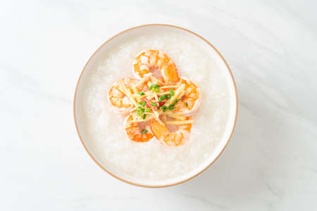 Congee with shrimps and fresh ginger on topの写真素材