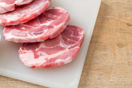 fresh pork neck raw or collar pork on board with ingredients for marinated