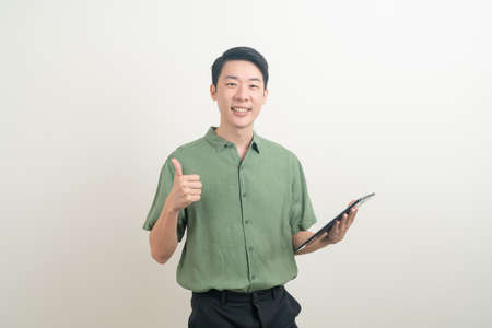 portrait young Asian man using tablet on white backgroundの写真素材