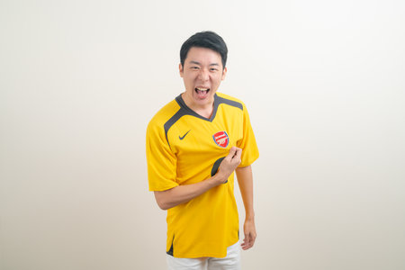 Bangkok, THAILAND - Nov 27, 2021 : Young Asian man wearing Arsenal shirt with white background. Arsenal football club is a famous team in London city.のeditorial素材