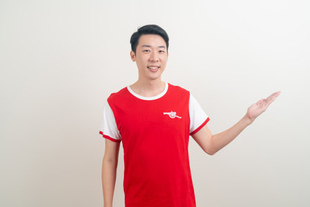 Bangkok, THAILAND - Nov 27, 2021 : Young Asian man wearing Arsenal shirt with white background. Arsenal football club is a famous team in London city.のeditorial素材