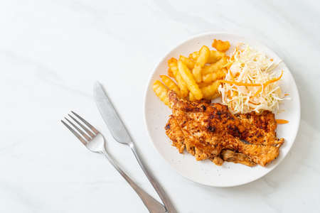 grilled spicy barbecue chicken steak with french friesの写真素材