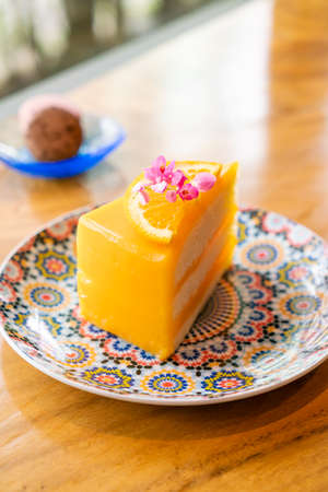 orange cake on beautiful plate in cafe restaurantの写真素材