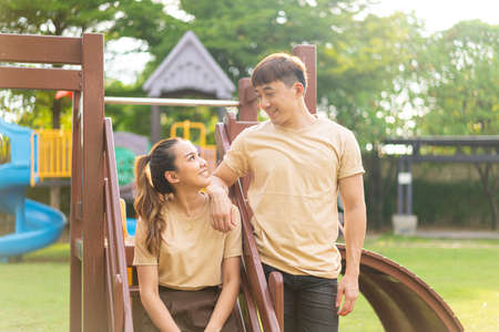 Asian couple love smiling in kids playground - dating conceptの写真素材