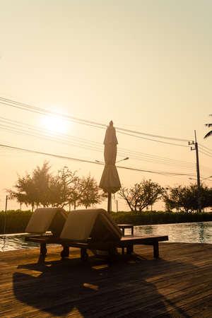 umbrella with bed pool around swimming pool with ocean sea background - holiday and vacation conceptの写真素材
