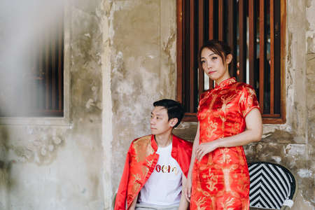 Happy young Asian couple love in Chinese traditional dresses - Red is the main color of the traditional festive that including wedding in China.の写真素材
