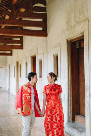 Happy young Asian couple love in Chinese traditional dresses - Red is the main color of the traditional festive that including wedding in China.の写真素材
