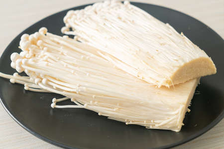 fresh enoki mushroom or golden needle mushrooms on plateの写真素材
