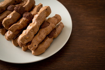 chocolate meringue stick on plate - French snack and dessert styleの写真素材