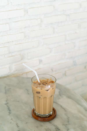 iced latte coffee glass on table in coffee shop cafeの写真素材