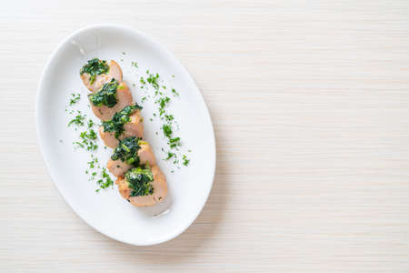 Chicken breasts stuffed with spinach and cheese on plateの写真素材