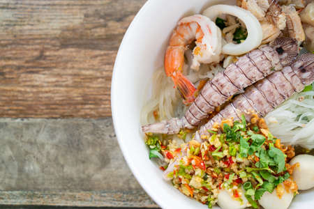 spicy seafood noodles bowl in Thai style - Tom Yum Noodles