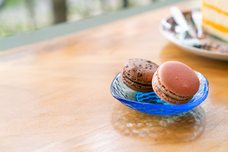 rose and chocolate macaron on plate in cafe restaurantの写真素材