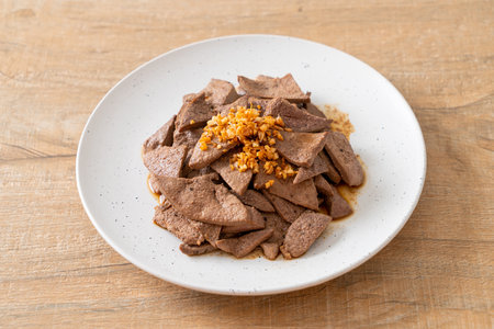homemade stir-fried pork liver with garlic on plateの写真素材