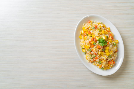 homemade fried rice with mixed vegetable (carrot, green bean peas, corn) and eggの写真素材