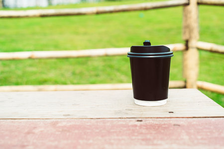hot coffee cup on wood table with Mountain hill View backgroundの写真素材