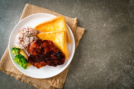 barbecue pork steak with rice berry on white plateの写真素材