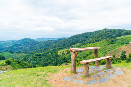 empty wood bar and chair with mountain hill backgroundの写真素材