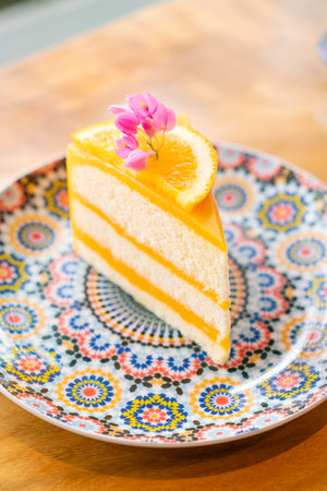 orange cake on beautiful plate in cafe restaurantの写真素材