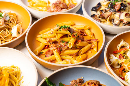 penne pasta with garlic chili bacon on plateの写真素材