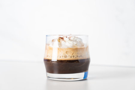 Coffee with Irish whiskey and whipped cream in glass - Irish coffee