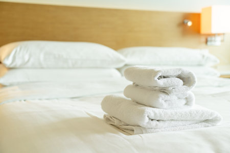 close-up white towel stack on bedの写真素材