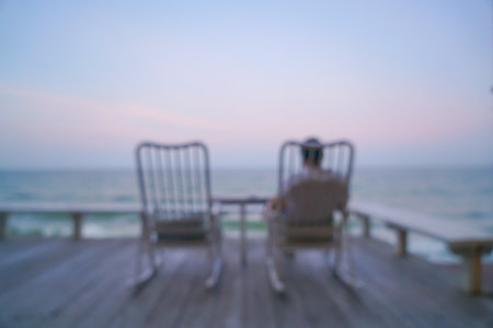 abstract blur chair on balcony with sea background at twilight timeの写真素材