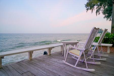 empty chair on balcony with sea background at twilight timeの写真素材