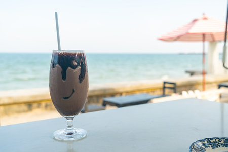 ice chocolate milkshake with ocean sea backgroundの写真素材