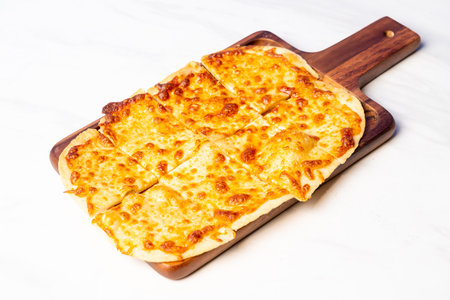tart flambe four cheese pizza on wood boardの写真素材