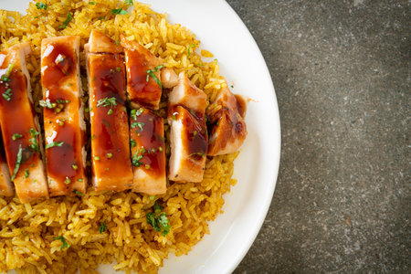 grilled sweet and chilli chicken with curry rice on plateの写真素材