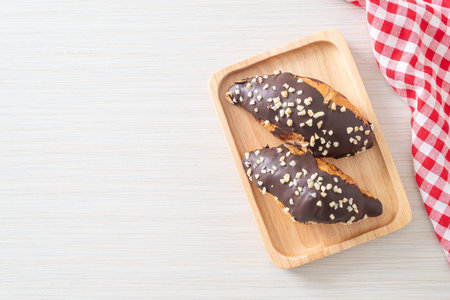 croissant with chocolate and nutty on wood plateの写真素材