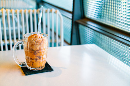 Thai tea ice scoop in glass on table in coffee shop cafe and restaurantの写真素材