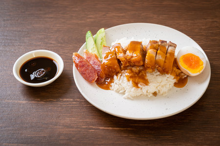 crispy belly pork on rice with barbecue red sauceの写真素材