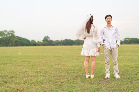 Happy young Asian couple in bride and groom clothing ready for marry and wedding celebrateの写真素材