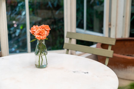 beautiful rose flower in vase decorated on table in cafe restaurantの写真素材
