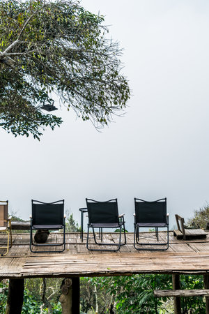 empty chair on balcony with mountain hill and foggy backgroundの写真素材