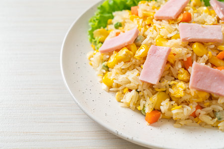 homemade fried rice with ham and mixed vegetable (carrot, green bean peas, carrot)の写真素材