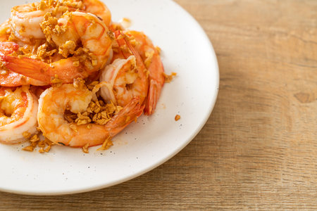 fried shrimps or prawns with garlic on white plate - seafood styleの写真素材