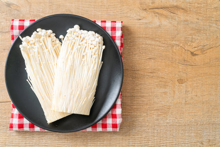 fresh enoki mushroom or golden needle mushrooms on plateの写真素材
