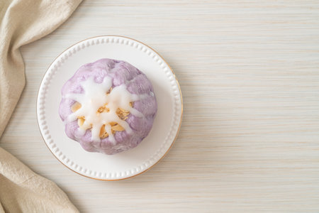 taro bun with white sugar cream and nut on topの写真素材