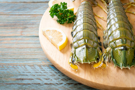 fresh mantis shrimp with lemon on wood boardの写真素材