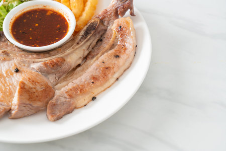 grilled pork chop steak with Thai spicy dipping sauce or Jaew sauce - fusion food styleの写真素材